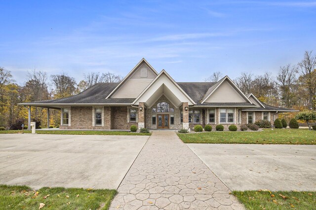 view of front facade with a front lawn and brick siding