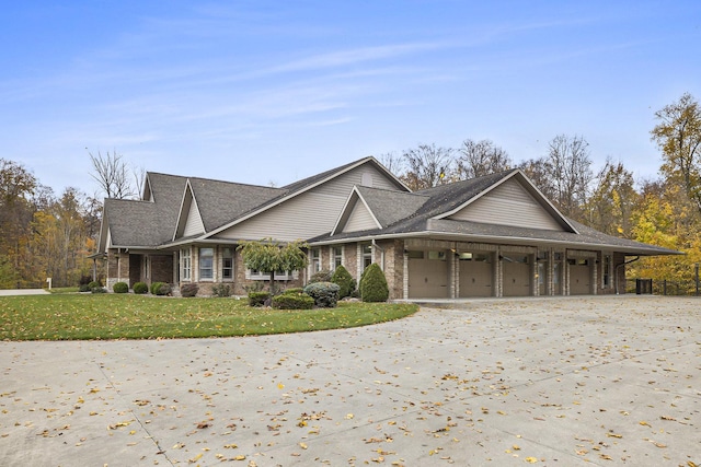 view of front facade with a garage, a front lawn, and brick siding