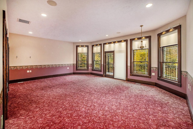 unfurnished room with dark colored carpet, visible vents, baseboards, and recessed lighting