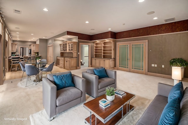 living room featuring french doors, visible vents, and recessed lighting