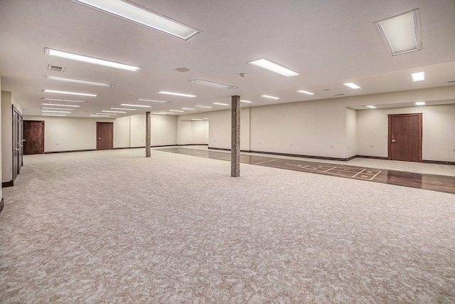 interior space featuring baseboards, visible vents, and light colored carpet