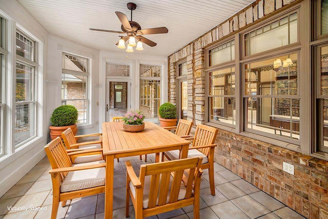 sunroom / solarium with a ceiling fan