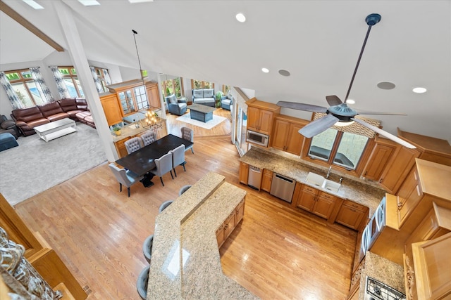 living room featuring vaulted ceiling, ceiling fan, light hardwood / wood-style floors, and sink