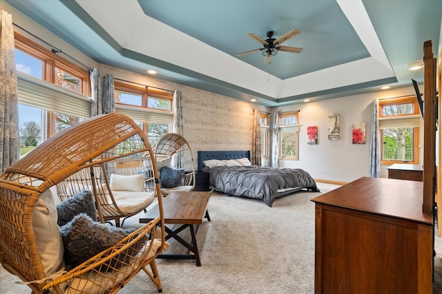 carpeted bedroom with a raised ceiling