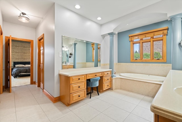 bathroom with decorative columns, vanity, and tile patterned flooring