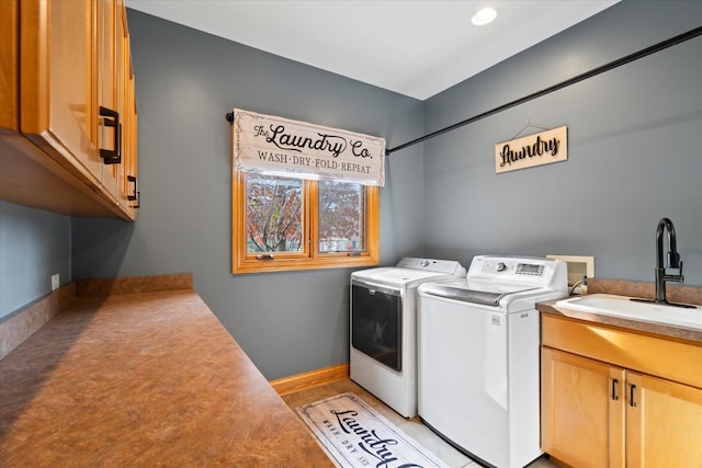 laundry area featuring sink, cabinets, and washing machine and clothes dryer