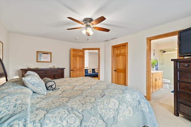 carpeted bedroom with ceiling fan and ensuite bathroom