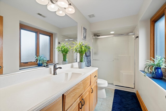 bathroom featuring vanity, toilet, and an enclosed shower