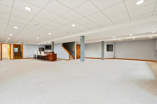 basement featuring carpet floors and a paneled ceiling