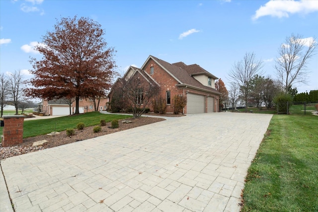 view of front of property with a garage and a front lawn