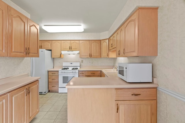 kitchen featuring light countertops, white appliances, light brown cabinets, and under cabinet range hood