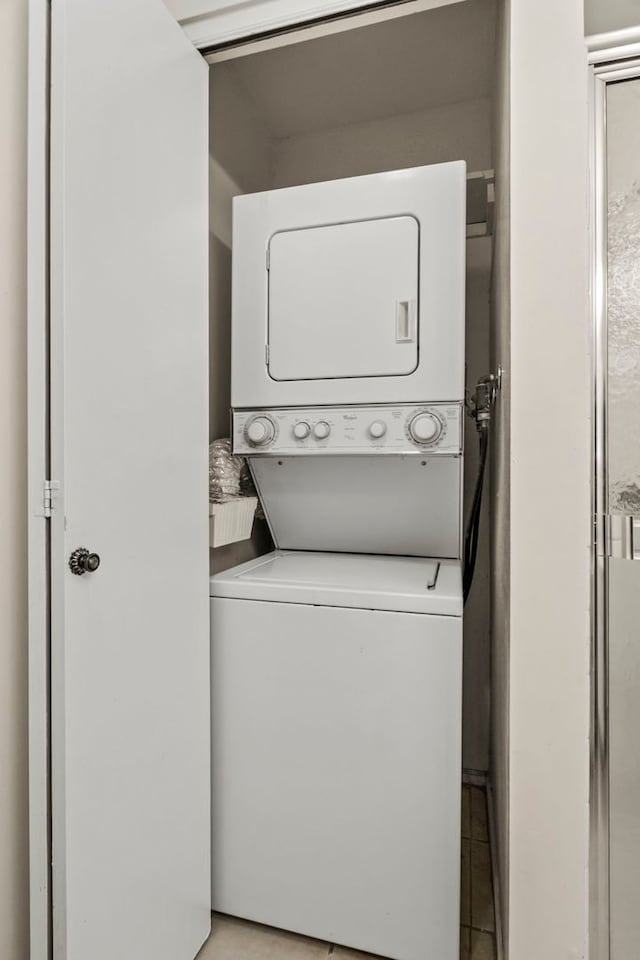 washroom featuring laundry area and stacked washer / dryer