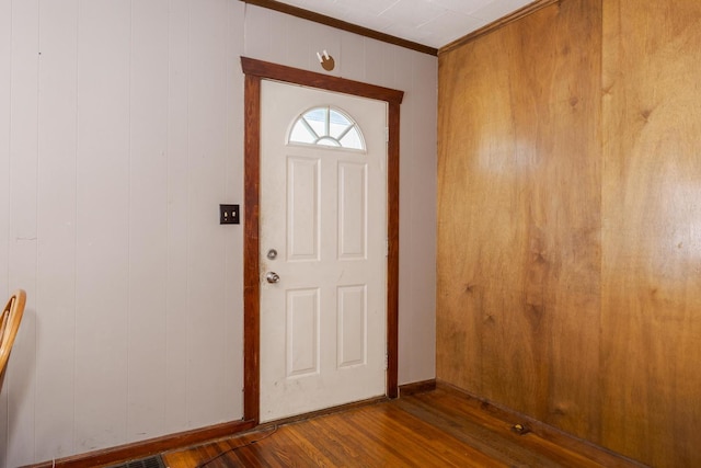 foyer with ornamental molding and hardwood / wood-style floors