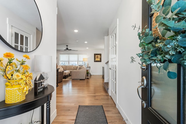 foyer entrance featuring baseboards, light wood-type flooring, a ceiling fan, and recessed lighting