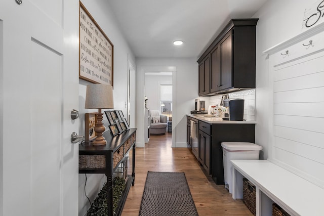 mudroom with light wood finished floors and baseboards