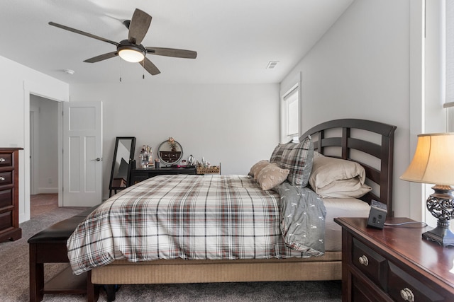 carpeted bedroom with ceiling fan and visible vents