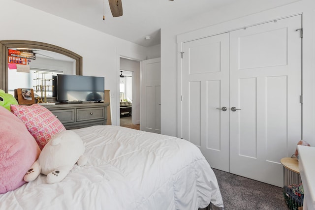 bedroom featuring a ceiling fan, a closet, and dark carpet