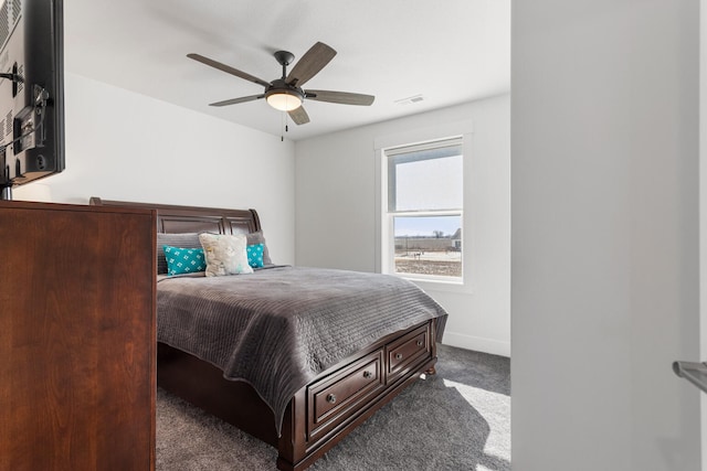 bedroom with ceiling fan, visible vents, baseboards, and dark colored carpet