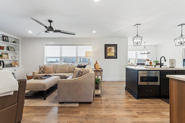 living room featuring recessed lighting, plenty of natural light, light wood-style flooring, and ceiling fan