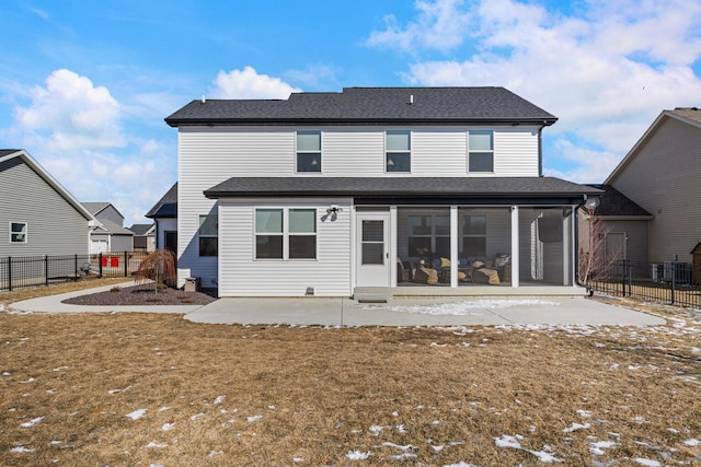 rear view of house featuring a patio, a lawn, a fenced backyard, and a sunroom