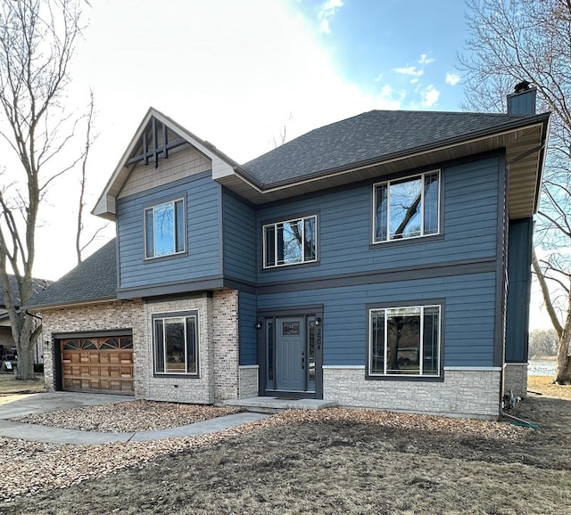 view of front of house featuring concrete driveway, roof with shingles, a chimney, and an attached garage