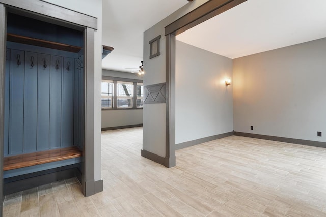 mudroom featuring light wood-style floors, ceiling fan, and baseboards