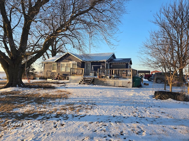 view of front of home featuring metal roof and a deck