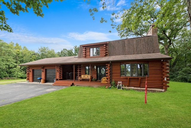 log-style house featuring a garage, covered porch, and a front yard