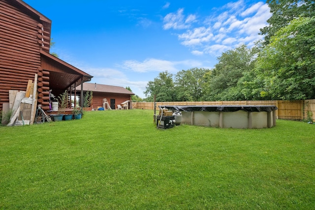 view of yard with a covered pool