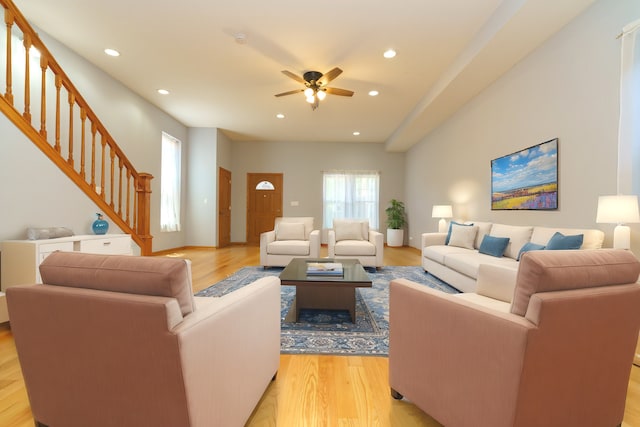 living room featuring light wood-style floors, stairway, and recessed lighting