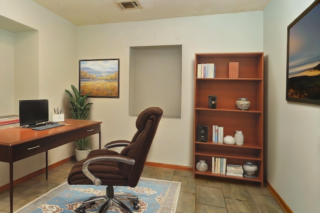 office space with baseboards and visible vents