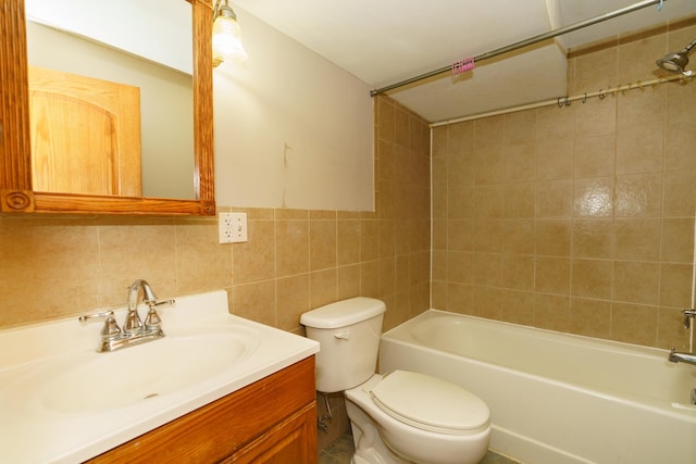 bathroom with toilet, washtub / shower combination, tile walls, and vanity