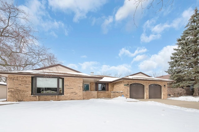 view of front of property featuring a garage and brick siding