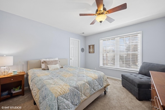 bedroom with light carpet, ceiling fan, and baseboards