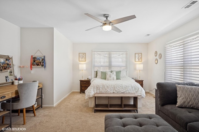 bedroom with a ceiling fan, light colored carpet, visible vents, and baseboards