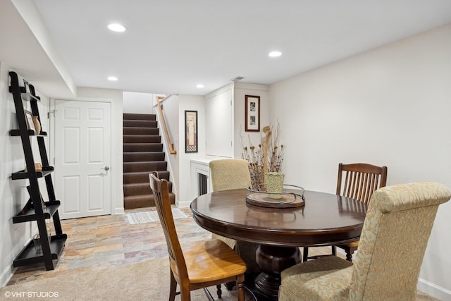 dining area featuring stairs, stone finish floor, baseboards, and recessed lighting