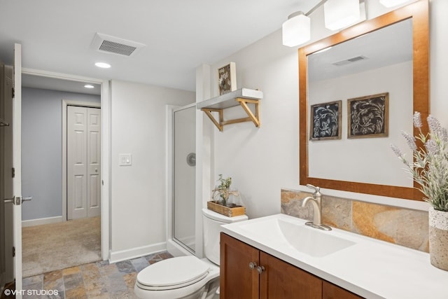 bathroom featuring a shower with door, visible vents, a closet, and vanity