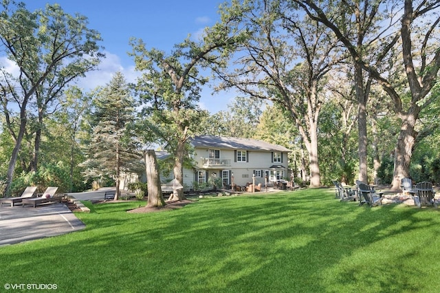 view of yard featuring a patio area and a balcony