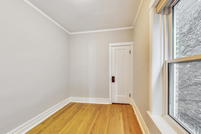 unfurnished room featuring crown molding and light wood-type flooring