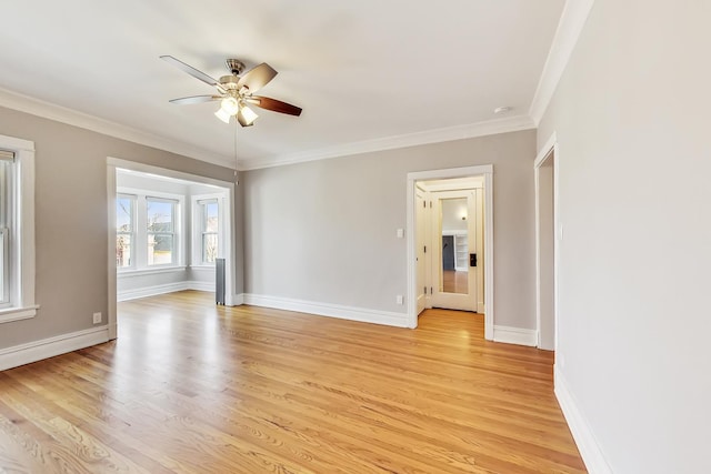 empty room with ornamental molding, ceiling fan, and light wood-type flooring