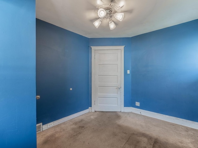 spare room with ceiling fan and carpet flooring