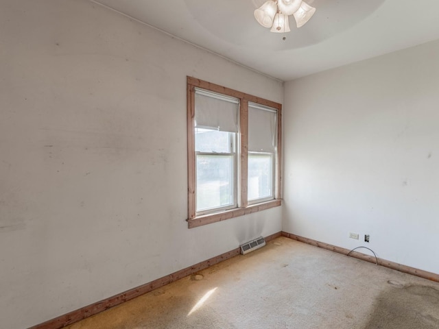 carpeted spare room with ceiling fan