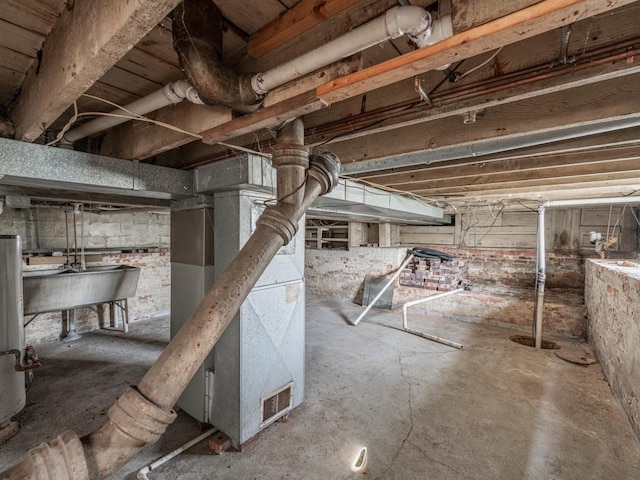 basement with sink and heating unit