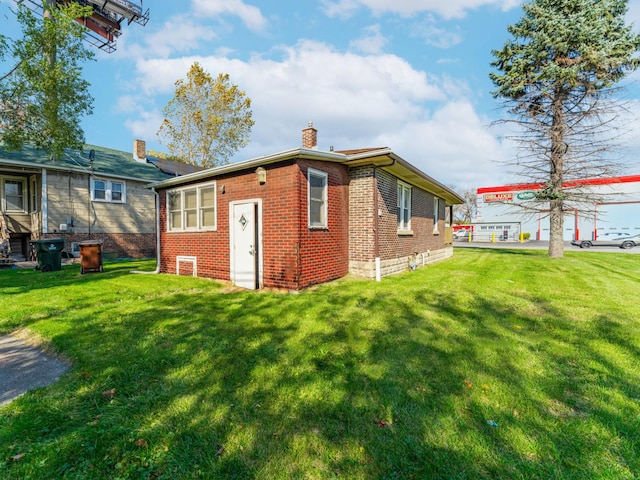 view of side of property with a lawn