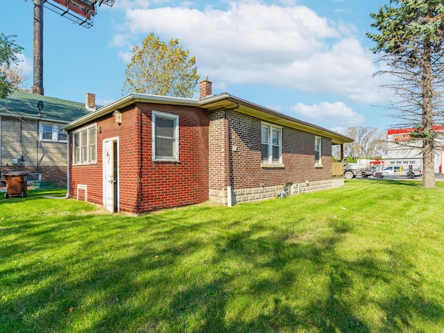 view of side of home with a lawn