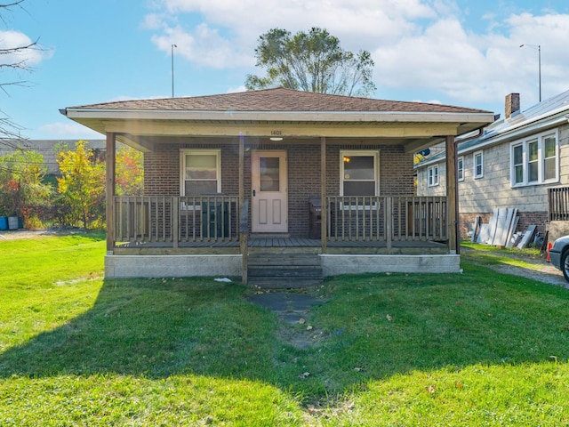 bungalow-style house with covered porch and a front yard