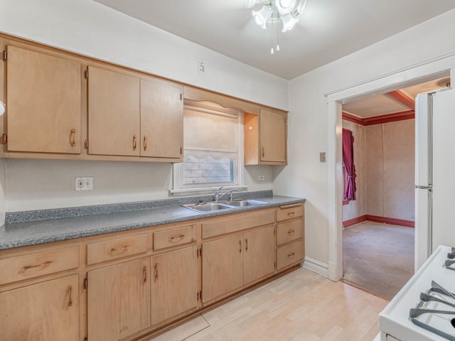 kitchen with sink, light brown cabinetry, white appliances, and light wood-type flooring