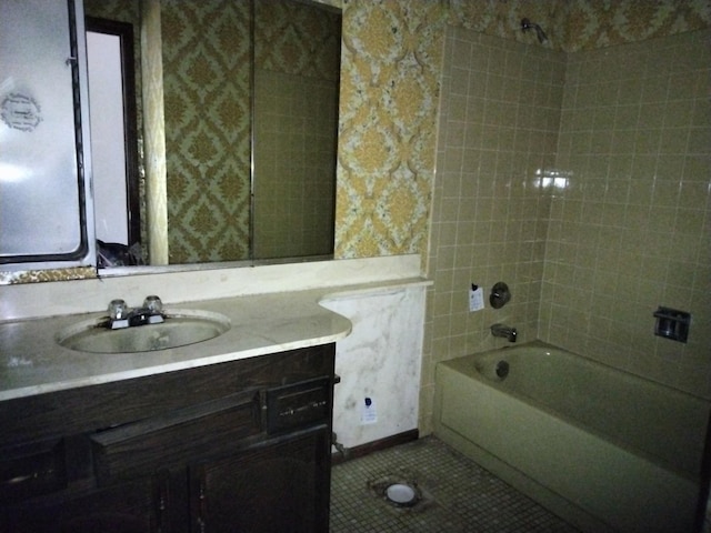 full bathroom featuring tile patterned floors, wallpapered walls, vanity, and washtub / shower combination