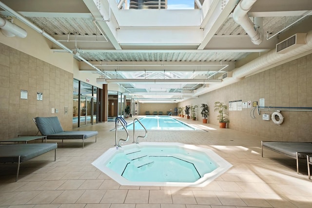 view of swimming pool featuring an indoor in ground hot tub