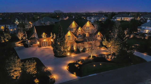 view of front of home with a patio area, a residential view, and stone siding